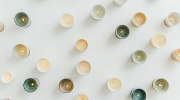 Top view image of multiple burning scented candles on a white background photo