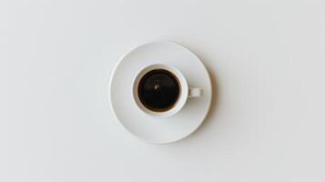 Top-down view of a white coffee cup on a saucer, filled with black coffee photo