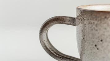 Speckled ceramic coffee cup filled with steaming coffee on a white background photo