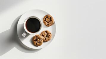 White coffee cup with coffee sitting on a white plate with chocolate chip cookies photo