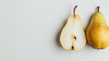 One and a half pears are lying on a white background, showing the inside of the fruit photo