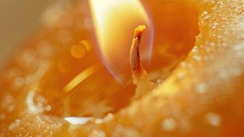 Warm and cozy candle creates a mesmerizing glow with melting wax and captivating bubbles photo