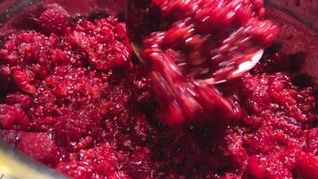 mash raspberries Close up of fresh, mashed, frozen, raspberry in metal container video
