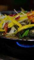 Fried white pomfret is a must-have New Year dish In Vietnam, delicious fish is cooked in a frying pan in a restaurant, immediately cooked in front of customers, boiling and bubbling in water video