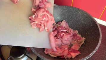 pieces of meat in a frying pan Fry pieces of meat in a frying pan. Meat in a frying pan is mixed with a wooden spatula. Meat boils in its own juice video