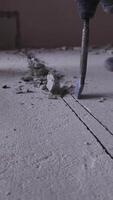 Close-up of a hammer drill in action, breaking through concrete with precision. The hammer drill powers through each layer, demonstrating the tool's strength and efficiency in tough conditions. video