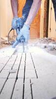 Watch a hammer drill break concrete close-up as the drill bit drives deep into the surface. The hammer drill's power is on full display, making quick work of the tough concrete. video