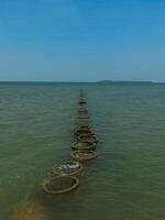 Manmade Pathway of Circular Structures Leading Far into the Sea with Endless Horizon photo