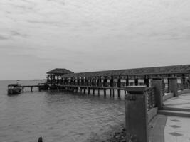 Jepara, Central Java, Indonesia - September 8, 2024, a small pier where fishing boats dock in black and white photo