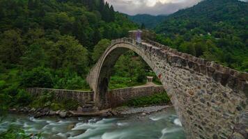 Senyuva Bridge or Senyuva Koprusu in Camlihemsin district of Rize with motion of the people and stream in time lapse 4k footage. video