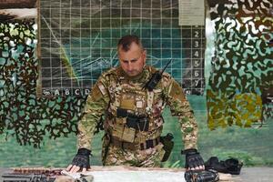 The esteemed leader of an elite military unit, strategic brilliance unfolds as he meticulously devises tactical plans for the upcoming military operation, surrounded by cutting-edge technology and a photo