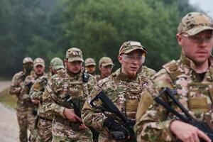 An elite military unit, led by a major, confidently parades through dense forest, showcasing precision, discipline, and readiness for high-risk operations photo
