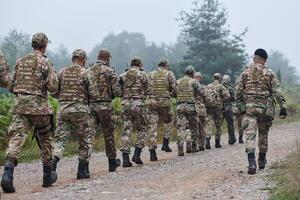 An elite military unit, led by a major, confidently parades through dense forest, showcasing precision, discipline, and readiness for high-risk operations photo