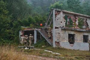 Elite military unit, equipped with state-of-the-art technology including a drone, strategically navigates and surveys dangerous wooded terrain, showcasing their precision, cooperation, and specialized photo
