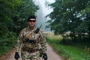 Elite soldier exudes focused determination and readiness, geared up for a perilous military operation, capturing the essence of courage and professionalism in the face of imminent danger photo