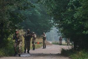 Elite military unit parading and securing the forest, utilizing drones for terrain scanning and reconnaissance, showcasing their advanced skills and specialized training in high risk operations photo