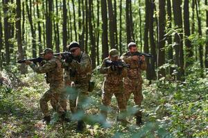 A specialized military antiterrorist unit conducts a covert operation in dense, hazardous woodland, demonstrating precision, discipline, and strategic readiness photo
