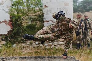 A highly trained elite military unit, clad in camouflage, skillfully navigates through perilous forest terrain, overcoming obstacles and executing a precise and covert mission photo