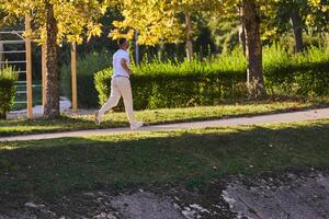 A handsome man maintains his healthy lifestyle as he runs along beautiful natural trails, embodying the essence of fitness, wellness, and vitality in the midst of scenic outdoor surroundings. photo