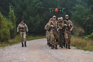 An elite military unit, led by a major, confidently parades through dense forest, showcasing precision, discipline, and readiness for high-risk operations photo
