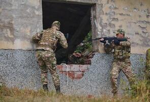 In a high stakes mission, a specialized military unit executes a tactical operation to secure a dangerous house where terrorists are believed to be hiding, showcasing precision and coordinated photo