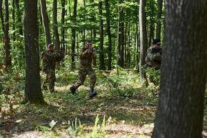 A specialized military antiterrorist unit conducts a covert operation in dense, hazardous woodland, demonstrating precision, discipline, and strategic readiness photo