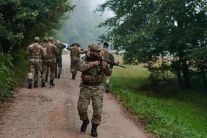 A group of elite soldiers leads captives through a military camp, showcasing a tense atmosphere of detention and security operations photo