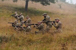 A disciplined and specialized military unit, donned in camouflage, strategically patrolling and maintaining control in a high-stakes environment, showcasing their precision, unity, and readiness for photo