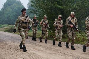 An elite military unit, led by a major, confidently parades through dense forest, showcasing precision, discipline, and readiness for high-risk operations photo