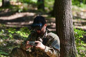 An elite soldier, equipped with state-of-the-art VR glasses, adeptly maneuvers a military drone, showcasing the seamless integration of cutting-edge technology in modern warfare photo
