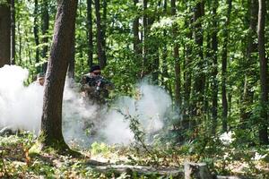 A specialized military antiterrorist unit conducts a covert operation in dense, hazardous woodland, demonstrating precision, discipline, and strategic readiness photo