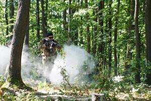 A specialized military antiterrorist unit conducts a covert operation in dense, hazardous woodland, demonstrating precision, discipline, and strategic readiness photo