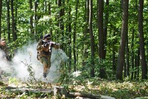 A specialized military antiterrorist unit conducts a covert operation in dense, hazardous woodland, demonstrating precision, discipline, and strategic readiness photo