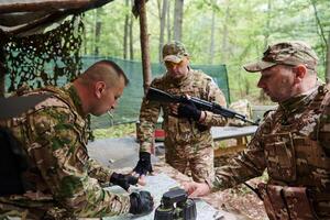 A highly trained military unit strategizes and organizes a tactical mission while studying a military map during a briefing session photo