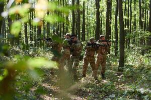 A specialized military antiterrorist unit conducts a covert operation in dense, hazardous woodland, demonstrating precision, discipline, and strategic readiness photo