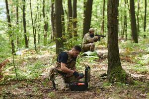 A specialized military antiterrorist unit conducts a covert operation in dense, hazardous woodland, demonstrating precision, discipline, and strategic readiness photo