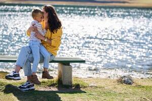 A mother and son create cherished memories as they playfully engage in outdoor activities, their laughter echoing the joy of shared moments and the bond between parent and child photo