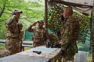 A highly trained military unit strategizes and organizes a tactical mission while studying a military map during a briefing session photo