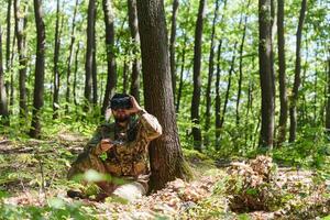 An elite soldier, equipped with state-of-the-art VR glasses, adeptly maneuvers a military drone, showcasing the seamless integration of cutting-edge technology in modern warfare photo