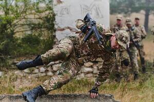 A highly trained elite military unit, clad in camouflage, skillfully navigates through perilous forest terrain, overcoming obstacles and executing a precise and covert mission photo