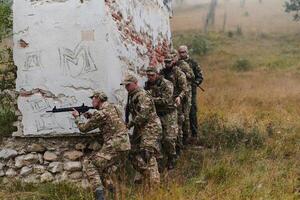 In a high stakes mission, a specialized military unit executes a tactical operation to secure a dangerous house where terrorists are believed to be hiding, showcasing precision and coordinated photo
