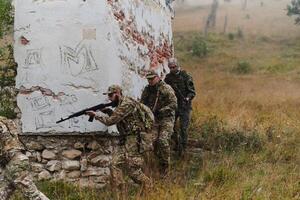 In a high stakes mission, a specialized military unit executes a tactical operation to secure a dangerous house where terrorists are believed to be hiding, showcasing precision and coordinated photo