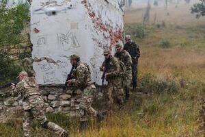 In a high stakes mission, a specialized military unit executes a tactical operation to secure a dangerous house where terrorists are believed to be hiding, showcasing precision and coordinated photo