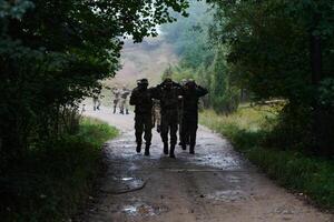 A group of elite soldiers leads captives through a military camp, showcasing a tense atmosphere of detention and security operations photo