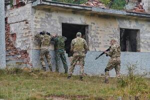 In a high stakes mission, a specialized military unit executes a tactical operation to secure a dangerous house where terrorists are believed to be hiding, showcasing precision and coordinated photo