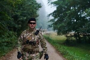 Elite soldier exudes focused determination and readiness, geared up for a perilous military operation, capturing the essence of courage and professionalism in the face of imminent danger photo