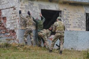 In a high stakes mission, a specialized military unit executes a tactical operation to secure a dangerous house where terrorists are believed to be hiding, showcasing precision and coordinated photo