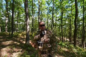 A military major employs a Motorola radio for seamless communication with his fellow soldiers during a tactical operation, showcasing professionalism and strategic coordination photo