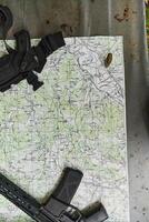 An array of military weapons, including rifles and pistols, is meticulously arranged on a table in a military base, presenting a close-up view of the diverse firepower and armament meticulously photo