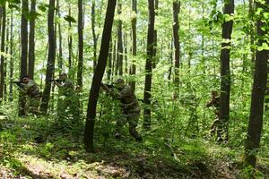 A specialized military antiterrorist unit conducts a covert operation in dense, hazardous woodland, demonstrating precision, discipline, and strategic readiness photo